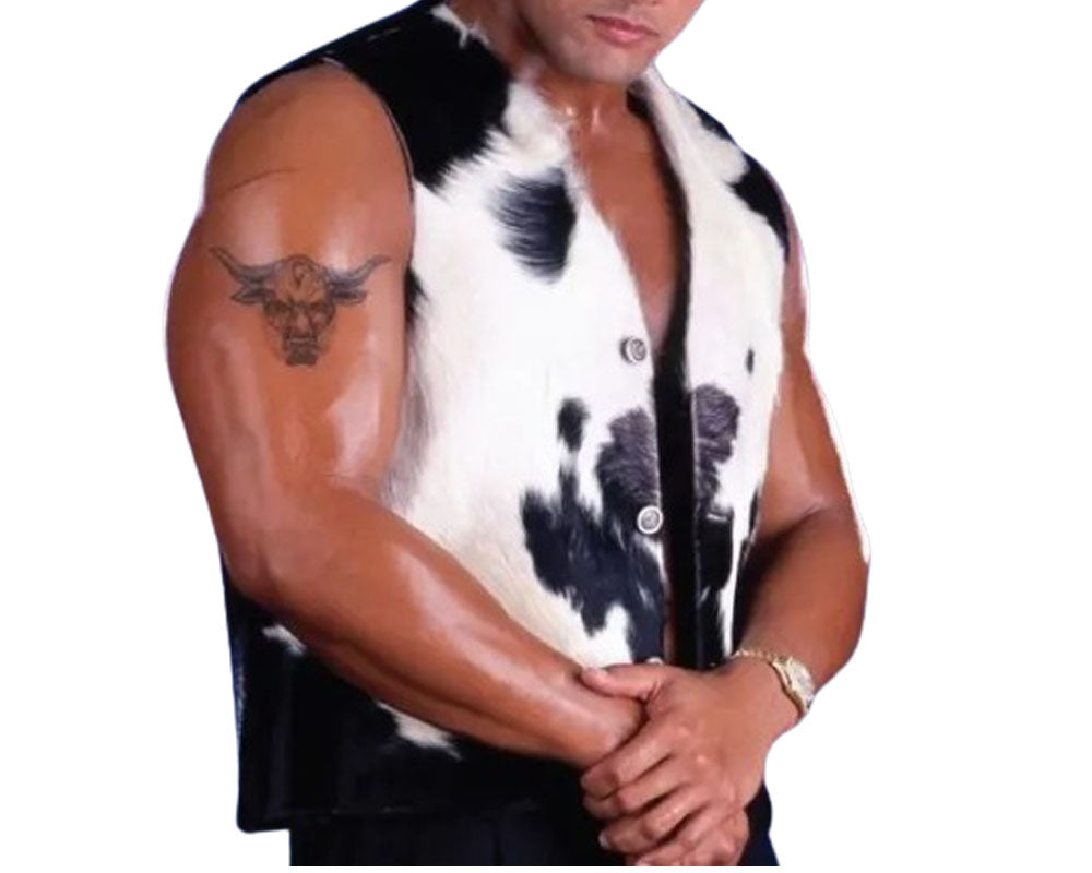 Person wearing a sleeveless cow print shirt on a white background