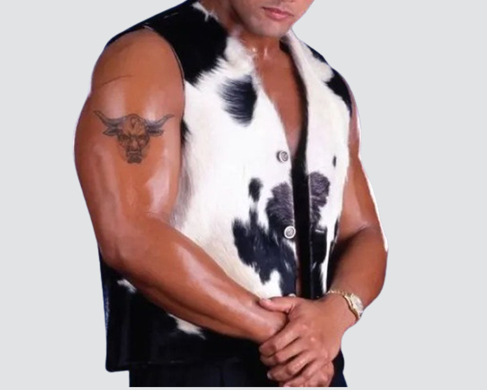 Person wearing a sleeveless cow print shirt on a plain background