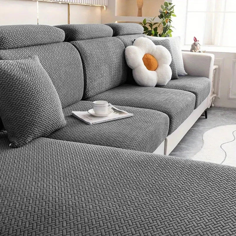 Gray sectional sofa with decorative pillows in a living room setting