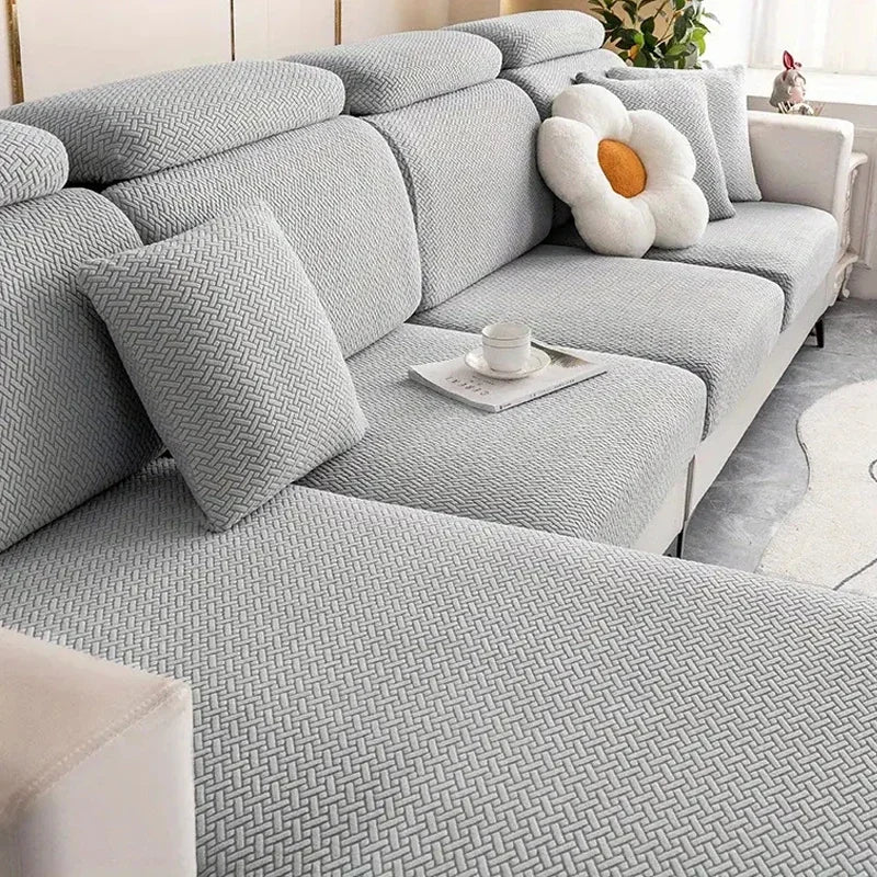 Gray sectional sofa with decorative pillows in a living room setting