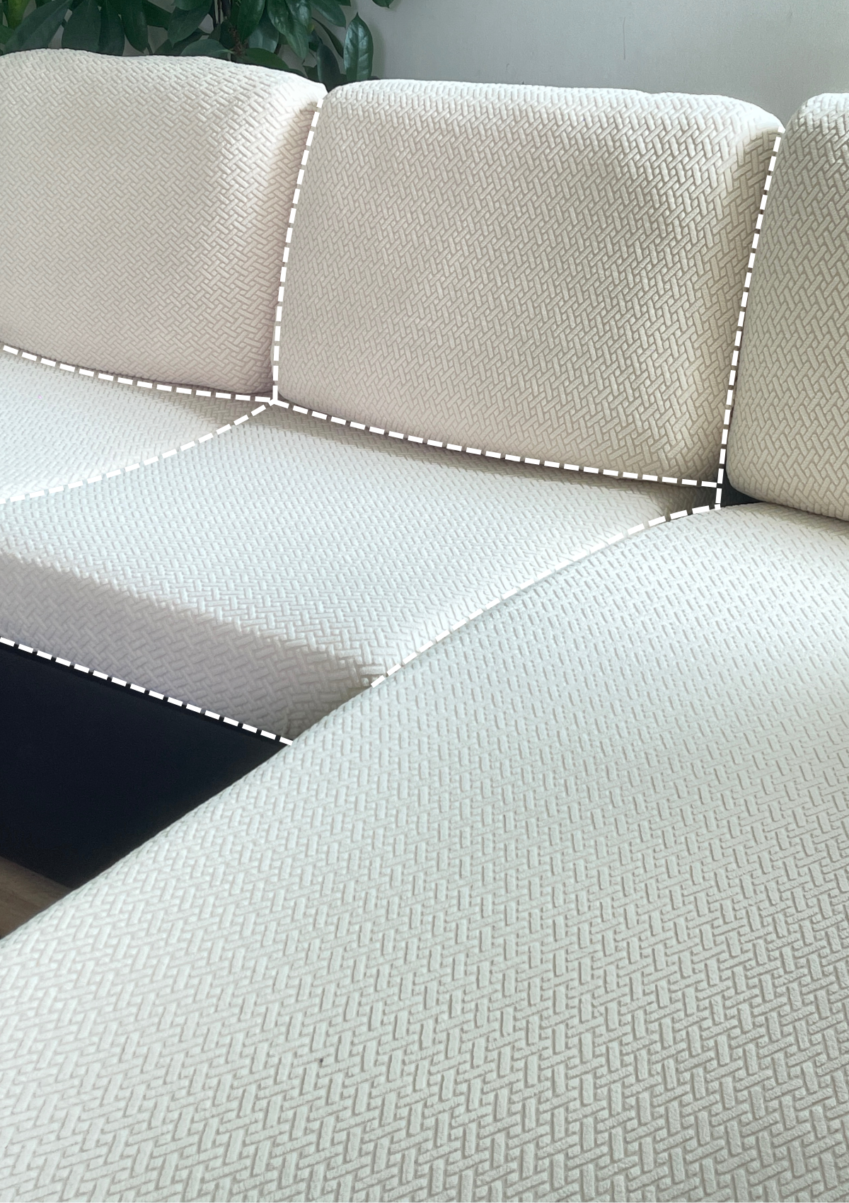 Close-up of cream textured pet-friendly sofa covers on an L-shaped couch, with dashed white lines highlighting the individual cushion sections for backrests and seats, against a light background with a potted plant in view.
