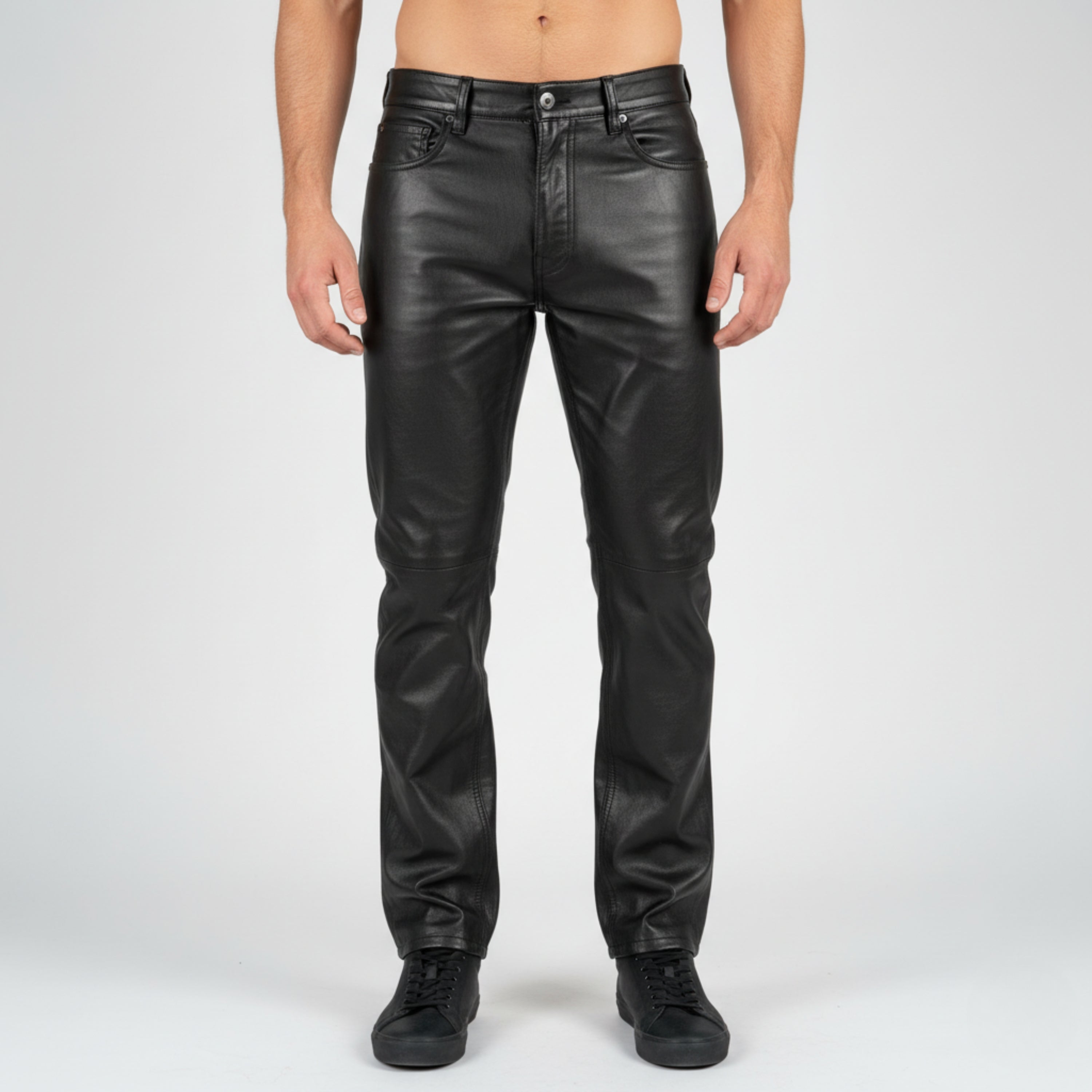 Person wearing black leather pants on a white background